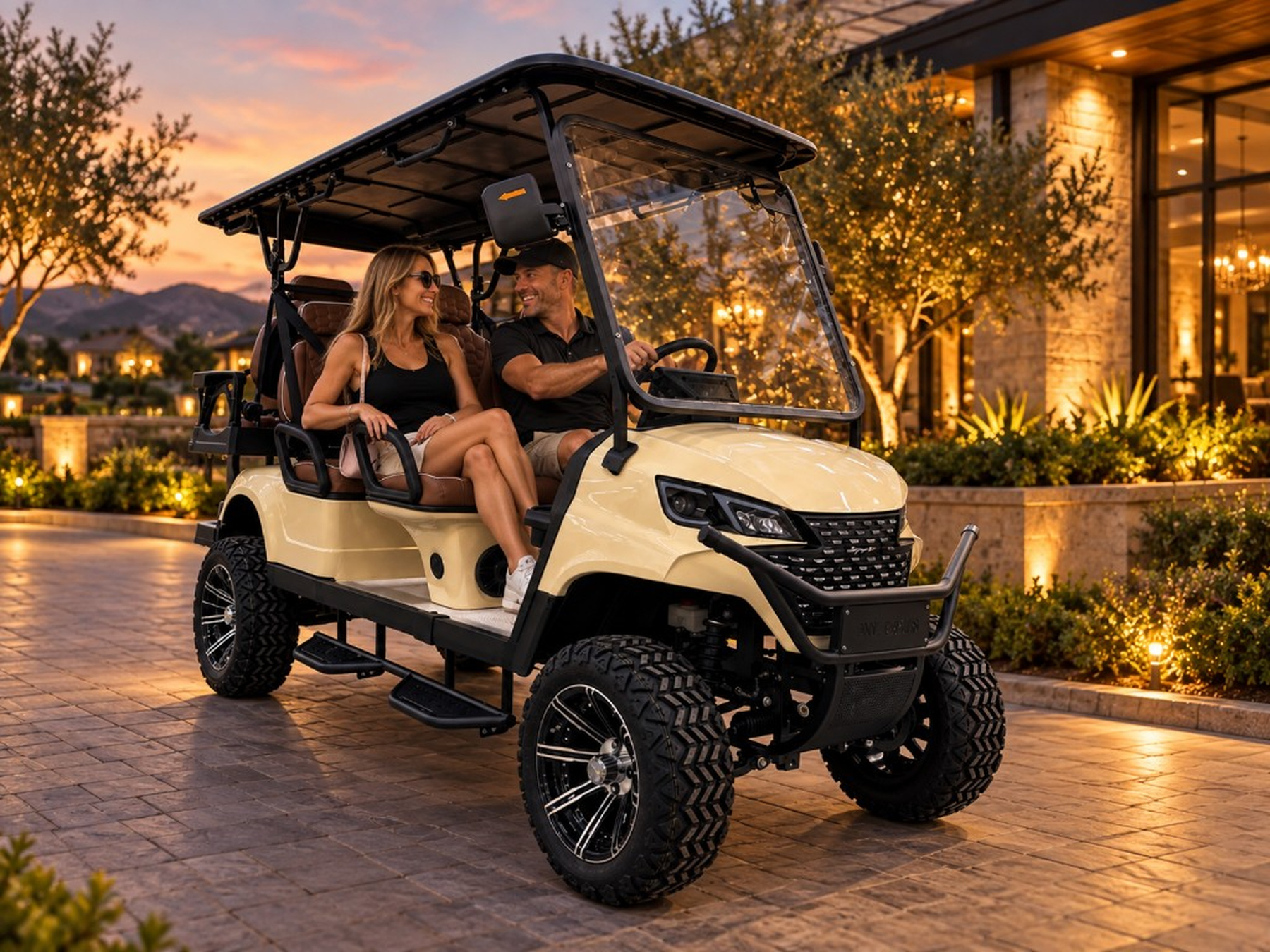 Cream ANT cart with guests at a resort showroom at sunset