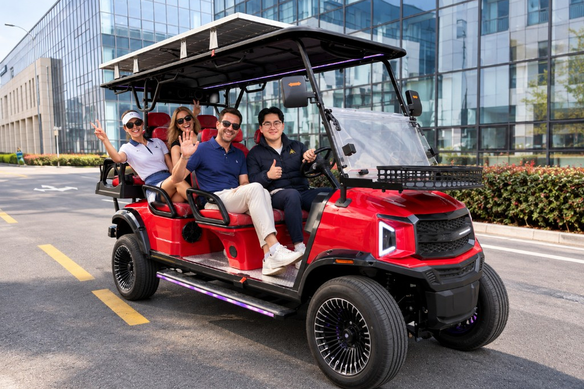 Red ANT 6 six-seat cart with guests waving and smiling